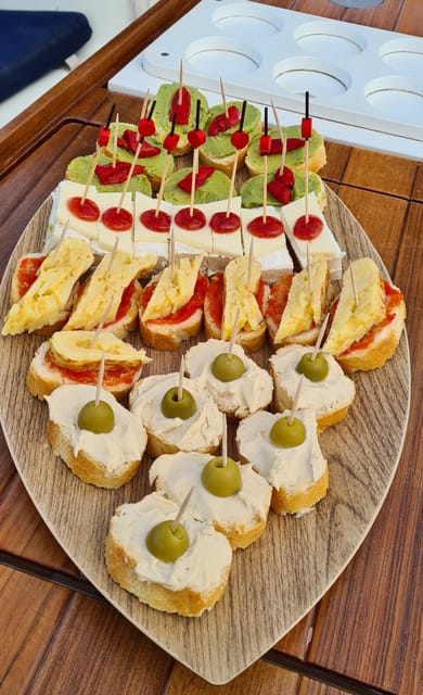 Barcelona: Sailing Tour with Spanish Tapas and Drinks - Tapas, snacks, and a glass of something local