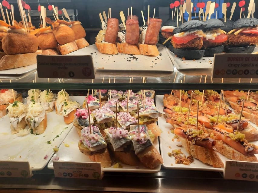 Barcelona: Tapas and Pintxos Tour with Crema Catalana - Starting with tapas and pintxos