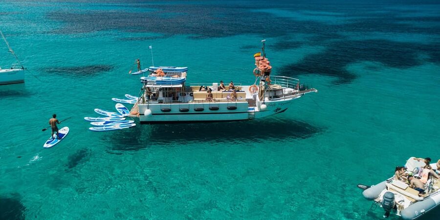 Ibiza: Scenic Sunset Cruise with Tapas and Drinks - Swimming in Ibiza’s clear water