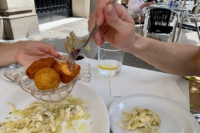 Lunchtime Tapas Tour in the Eixample with The Barcelona Taste - Walking Passeig de Sant Joan between bites