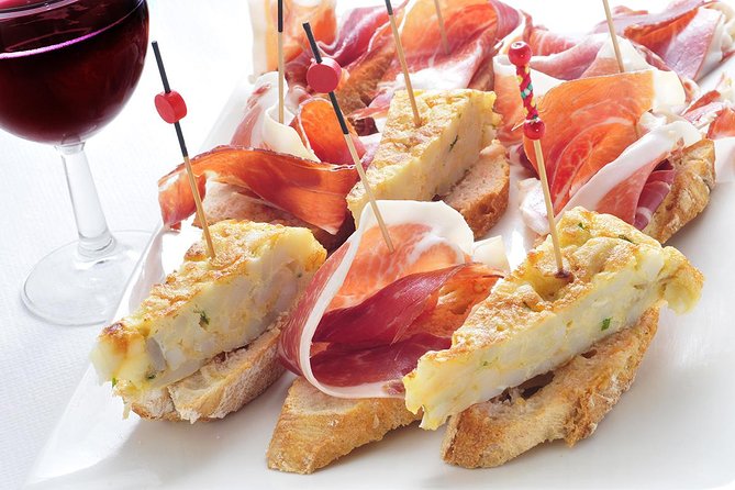 Madrid Tapas Experience Walking Tour - First tastes: paella, croquettes, and patatas bravas