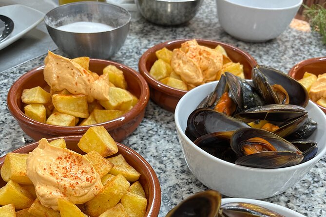 Seafood paella cooking class, tapas and visit to Ruzafa market. - Meeting at San Valero Parish