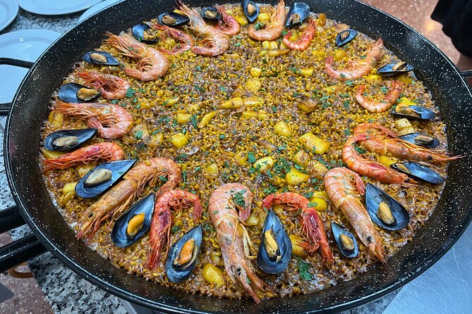 Seafood paella cooking class, tapas and visit to Ruzafa market. - Sitting down to eat your paella