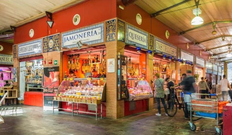 Seville: Tasting, History, Market visit and Tapas Tour - A traditional tapas bar with old earthenware vats
