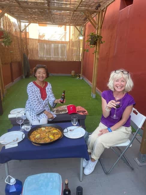 Valencia: Paella Cooking Class with Tapas and Drinks - Eating the paella on a Valencian terrace